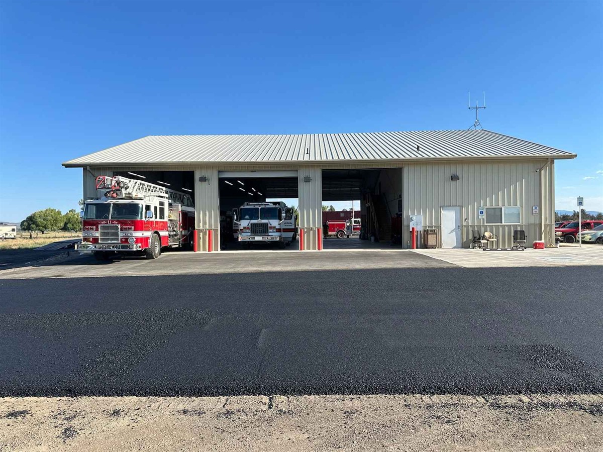 Fresh asphalt parking lot outside a Central Oregon service facility
